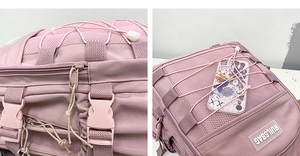 Detail of pink backpack featuring elastic bungee cords and breathable mesh pockets