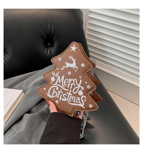 Close-up of brown Christmas tree-shaped handbag with Merry Christmas text and silver chain