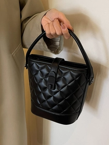 Classic black quilted bucket bag with diamond lattice pattern and wide top handle