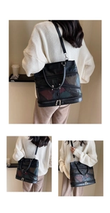 Macro view of geometric patchwork leather tote bag with multi-zipper detail