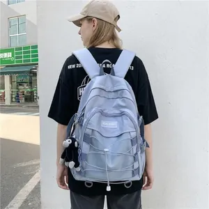Waterproof light blue nylon backpack with mesh compartment and black monkey pendant charm