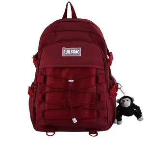 Trendy burgundy nylon backpack for women with crisscross cord and plush monkey keychain