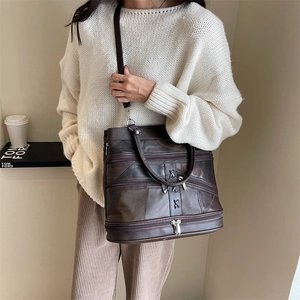 Brown leather patchwork tote bag with triple zipper pockets and adjustable shoulder strap