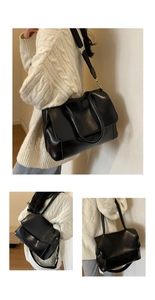 Close-up of black PU leather tote bag featuring a wide adjustable strap and dual handles