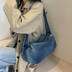 Japanese style denim cylinder crossbody bag with metallic eyelets and wide shoulder strap