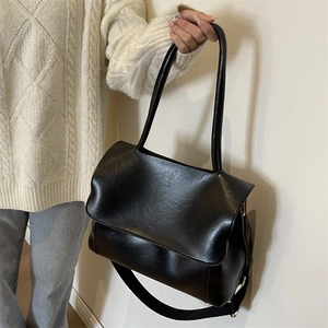 Black large capacity faux leather tote bag with wide detachable crossbody strap for women