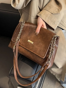 Brown vintage faux leather shoulder bag with gold chain strap and metal buckle closure