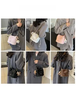 Detail shots showing five colors of the drawstring bucket bag with gold chain straps