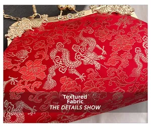 Close-up of vintage red silk evening bag with dragon embroidery and diamond buckle