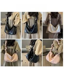Detail view of large pleated shoulder bags in black, silver, and pink PU leather material