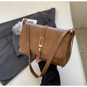 Vintage brown leather shoulder bag with gold clasp and textured finish for women