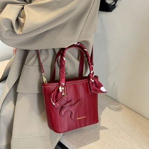 Elegant deep red bridal bucket bag with wave texture and silk scarf wrapped handle