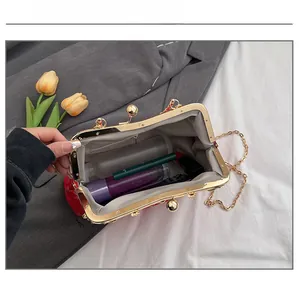 Interior view of red silk shell bag showing capacity for lipstick and makeup items