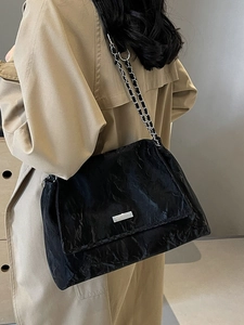 Minimalist black pleated shoulder bag with silver chain strap and cloud texture for women