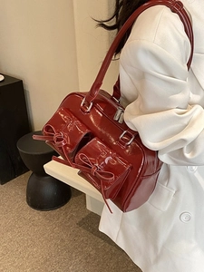 Minimalist deep red patent leather shoulder bag with chic bow and silver hardware detail