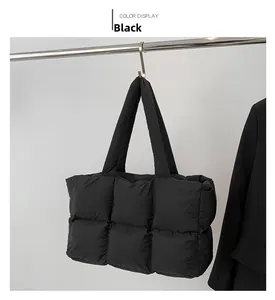 Detail view of a black quilted puffer tote bag with spacious compartment and padded straps