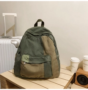 Detailed close-up of a vintage canvas backpack featuring green and khaki patchwork design