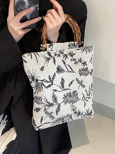 Bamboo handle canvas tote bag with elegant floral embroidery and vintage aesthetic