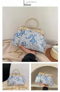 Silver silk handbag with dragon embroidery, gold circular handle and metal chain strap