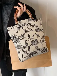 Chic canvas tote with bamboo handle featuring vintage dragonfly and floral embroidery print