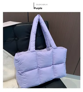 Detailed close-up of light purple quilted puffer tote bag with thick padded top handles