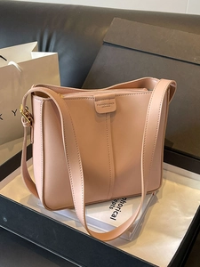 Fashionable dusty pink leather bucket bag with shoulder strap in a luxury gift box setting