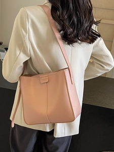 Chic pink leather bucket bag with top zip closure and stylish shoulder strap for women