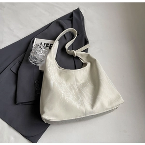 Gros plan détaillé du sac hobo blanc crème avec texture similicuir froissé et coutures