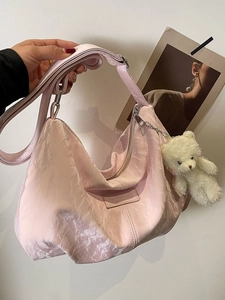 Pink crescent hobo bag with pleated texture and cute white plush bear pendant