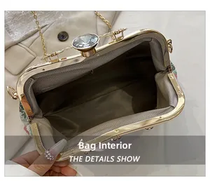 Interior view of floral evening bag with golden frame and gemstone clasp detail