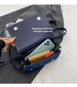 Internal view of denim crossbody bag showing space for phone and quilted wallet
