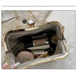 Interior view showing capacity of floral jacquard clutch with makeup essentials