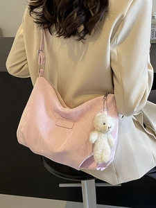 Pink minimalist crescent tote bag in pleated faux leather with plush bear keychain charm
