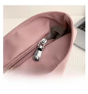 Close-up of pink nylon tote with premium silver zipper and herringbone fabric lining