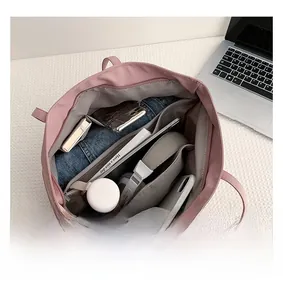 Internal view of the light pink tote bag showing large capacity and multi-pocket organization