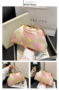 Detailed macro view of floral silk jacquard handbag with sparkling rhinestone handle