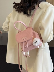 Pink vintage mini backpack in matte leather style with drawstring and plush charm