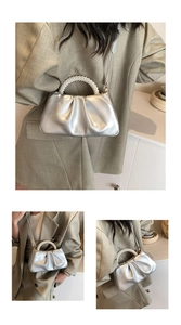 Detail of silver metallic cloud bag with white pearl handle and delicate shoulder strap
