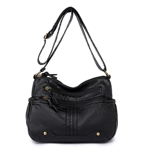 Sac bandoulière en cuir lavé noir avec plusieurs poches zippées et sangle réglable