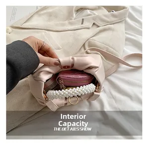 Interior view showing capacity of the pink pleated cloud bag with pearl handle