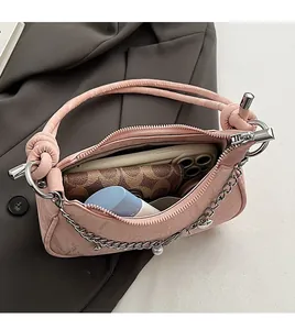 Internal view of pink pleated handbag showing space for smartphone and long wallet