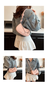 Detailed view of pink crescent hobo bag with silver chain and pearl charm