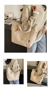 Detail view of large canvas tote bag showing multiple pockets and cream fabric texture