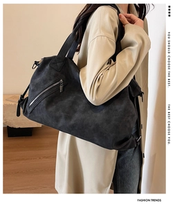 Close-up of black matte tote bag featuring a stylish diagonal zipper pocket and soft texture