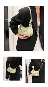 Detail view of matcha green crescent bag with silver chain and star pearl pendants