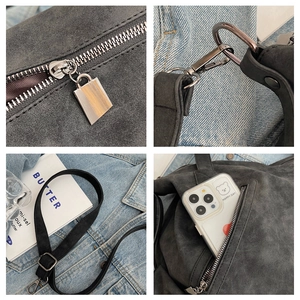 Macro details of gray suede tote bag with silver hardware and adjustable strap