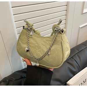Detail of light green crescent underarm bag with pleated leather and decorative chain