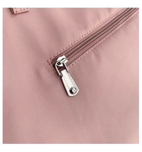 Detailed close-up of pink nylon fabric with high-quality zipper and silver metal slider