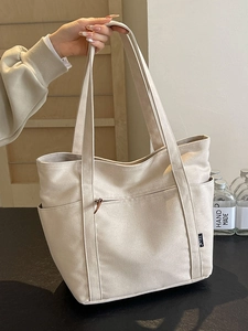 Large capacity off-white canvas tote bag with multi-pocket design for daily commute