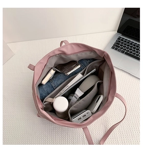 Pink nylon tote bag interior showing large capacity with compartments for daily items
